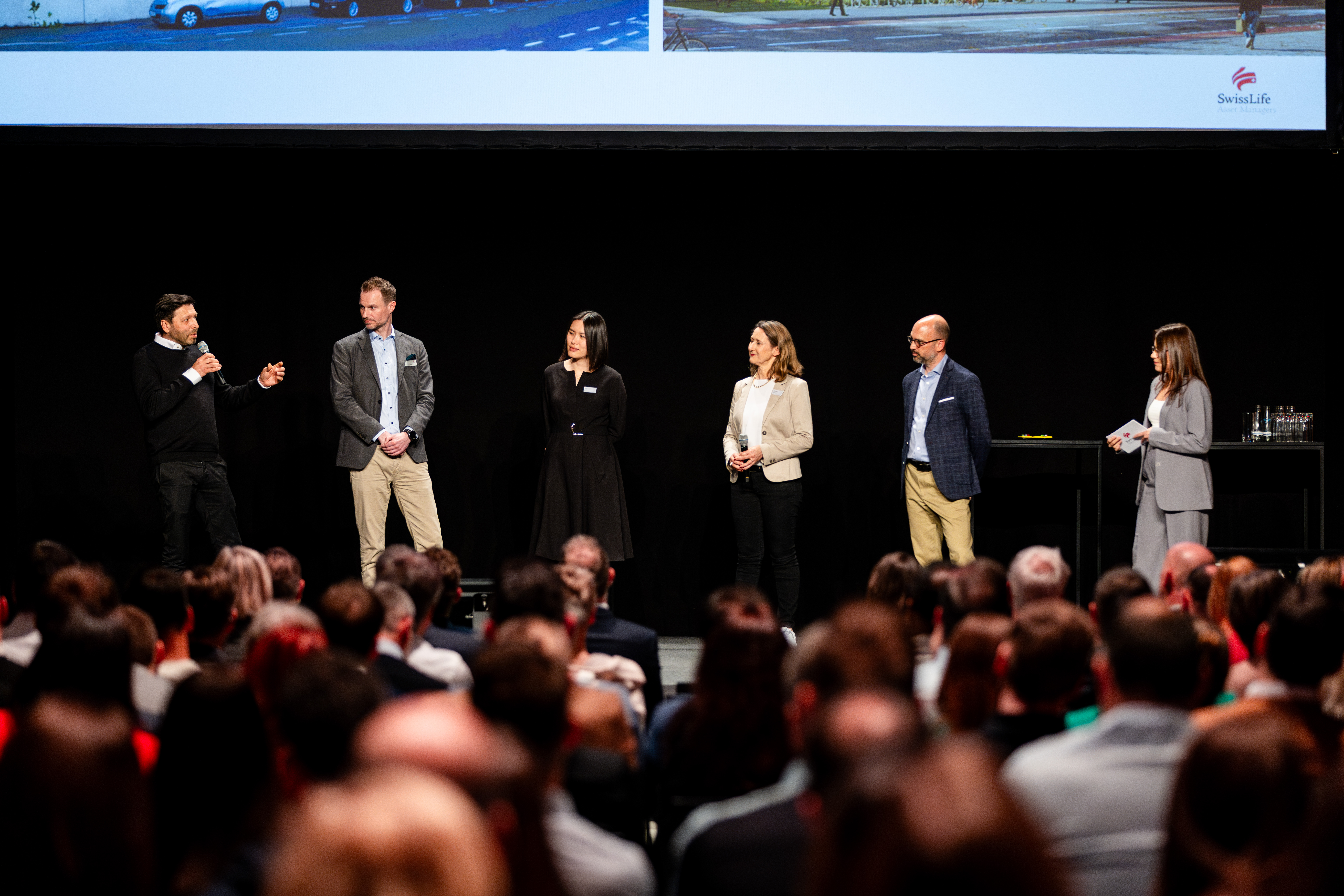 Employees on stage at the Swiss Life Asset Managers annual