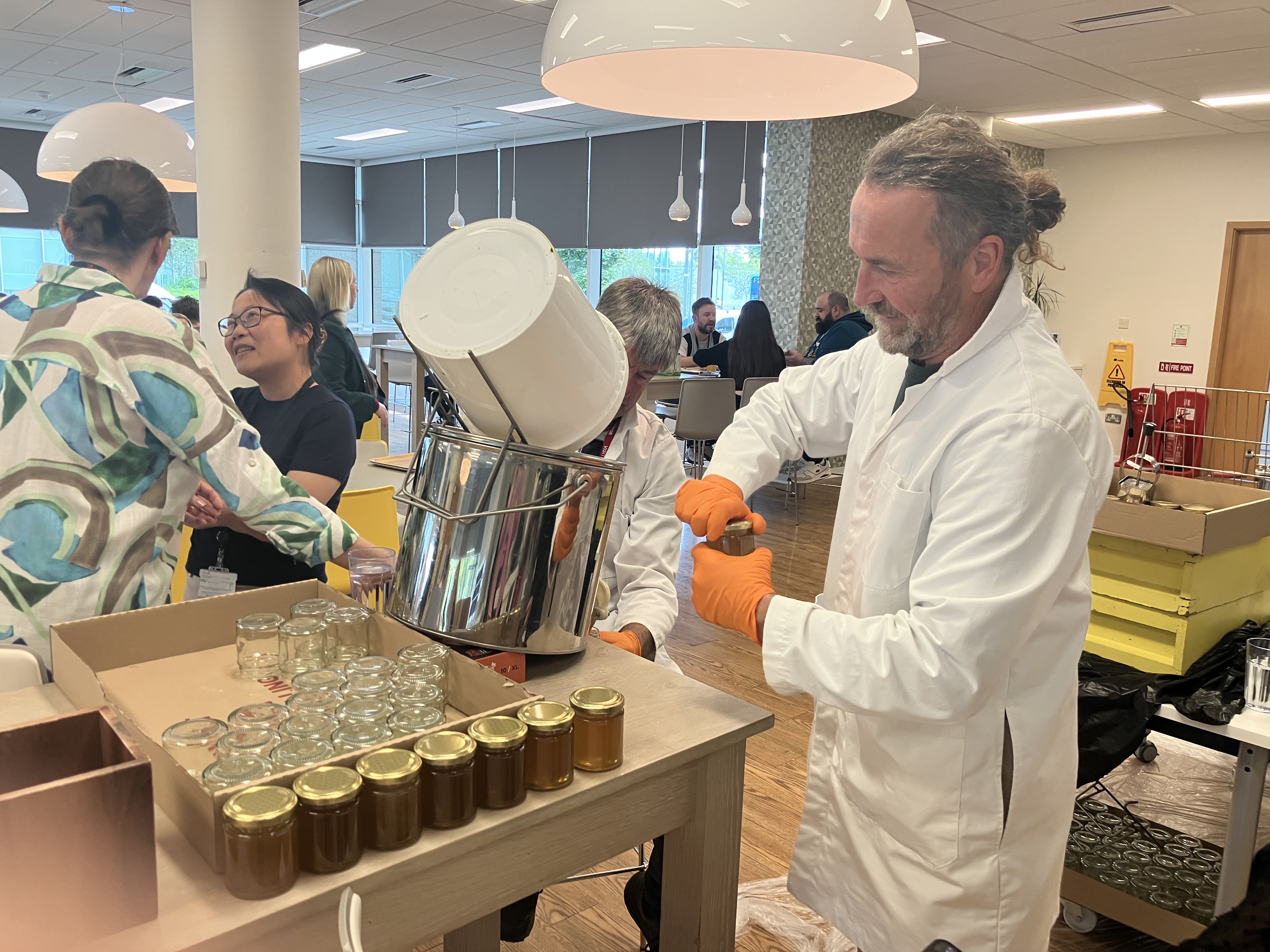 Aviva's beekeepers spinning honey from our office hives for employees