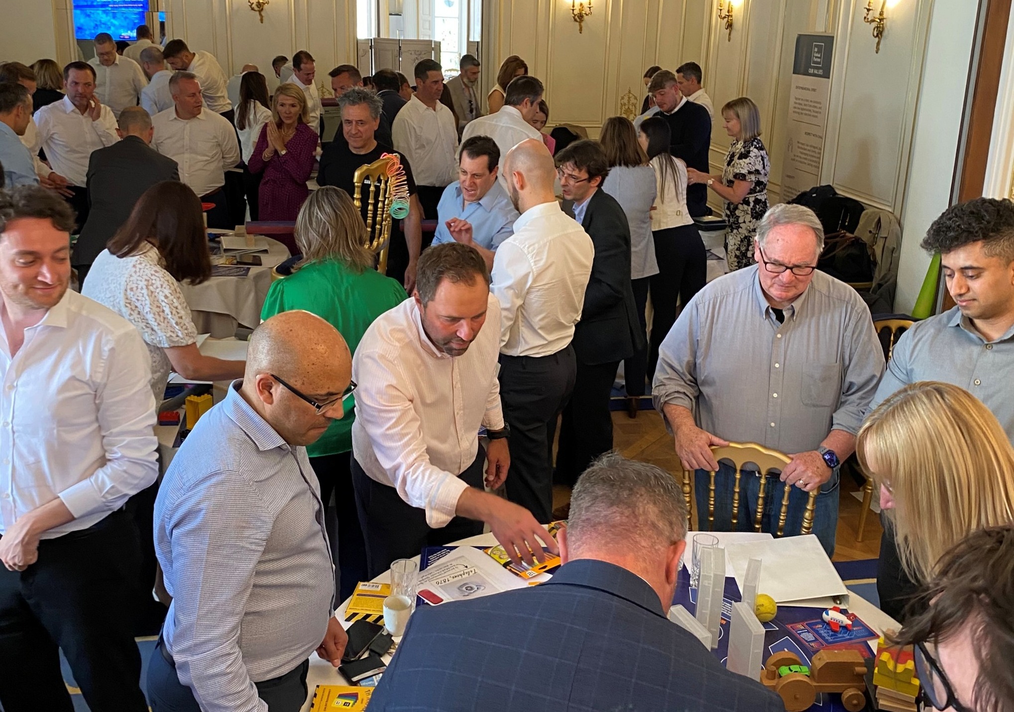 Employees engaging in a problem-solving activity together at our annual internal team event.