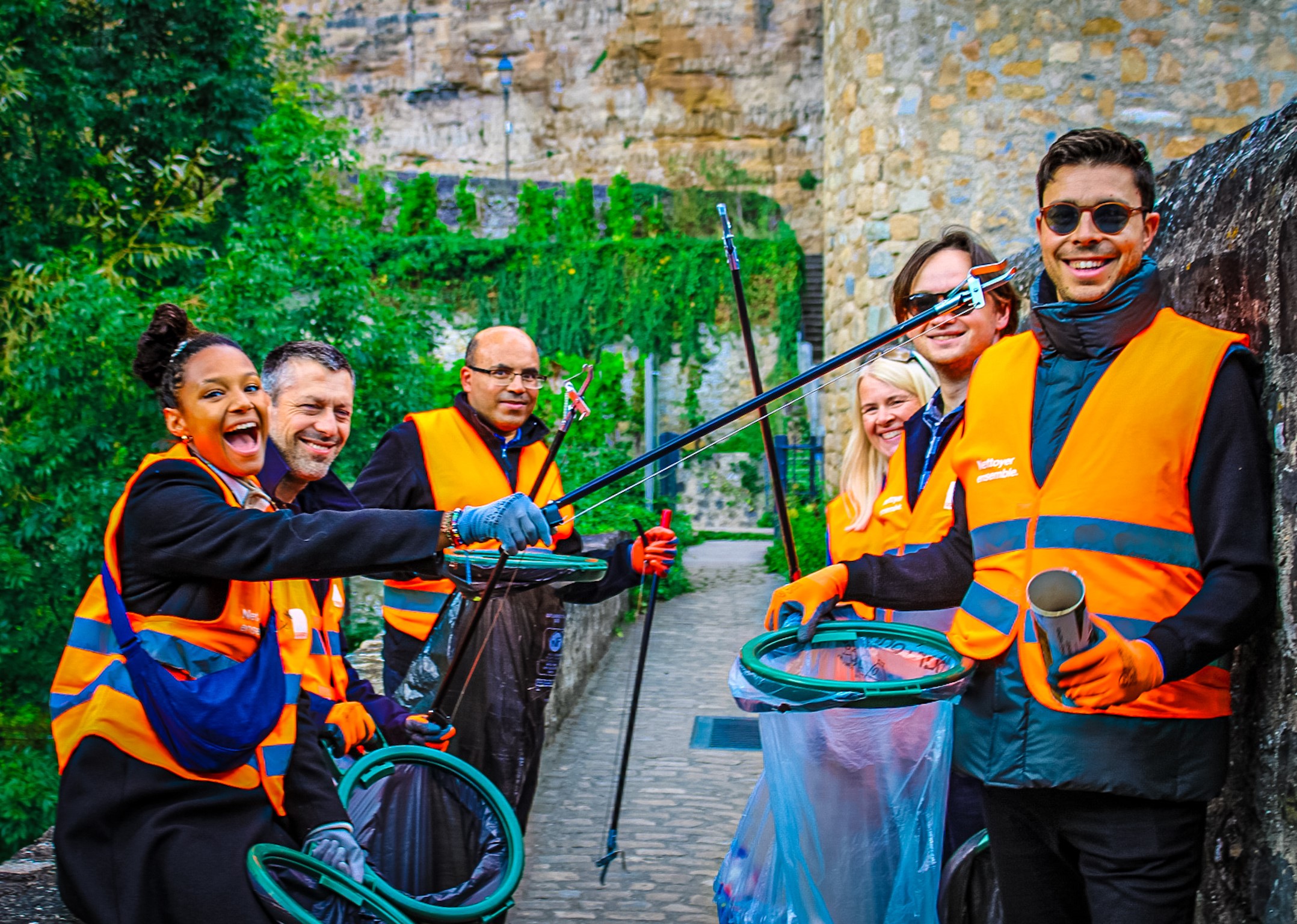 Employees volunteering to clean up the streets of Luxembourg, improving their local community.